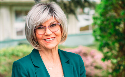 headshot of marilyn osgood in front of trees