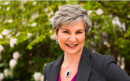 headshot of susan mcconnell in front of trees