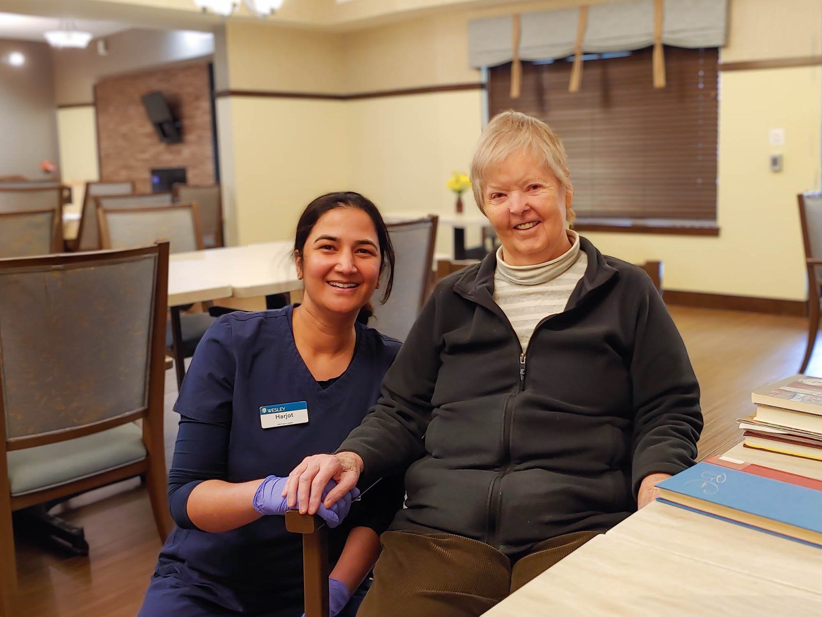 Harjot Caregiver with resident at Wesley Bradley Park Arbor Memory Care